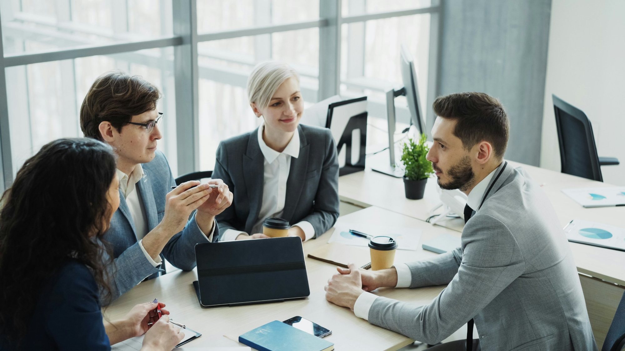 A manager leading a team discussion in a modern office